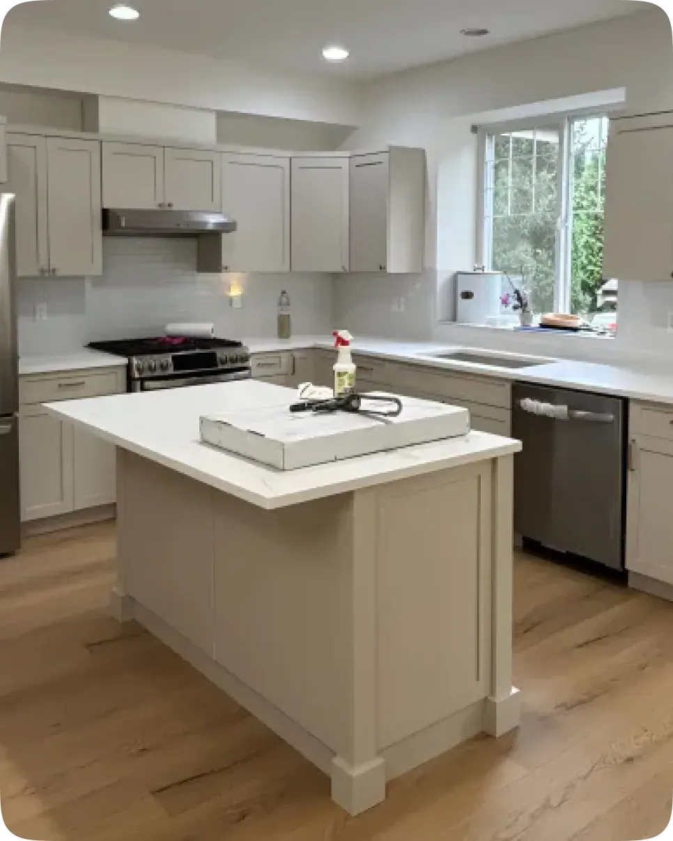 Renovated kitchen with a large island in a Metro Vancouver home renovated by PCC