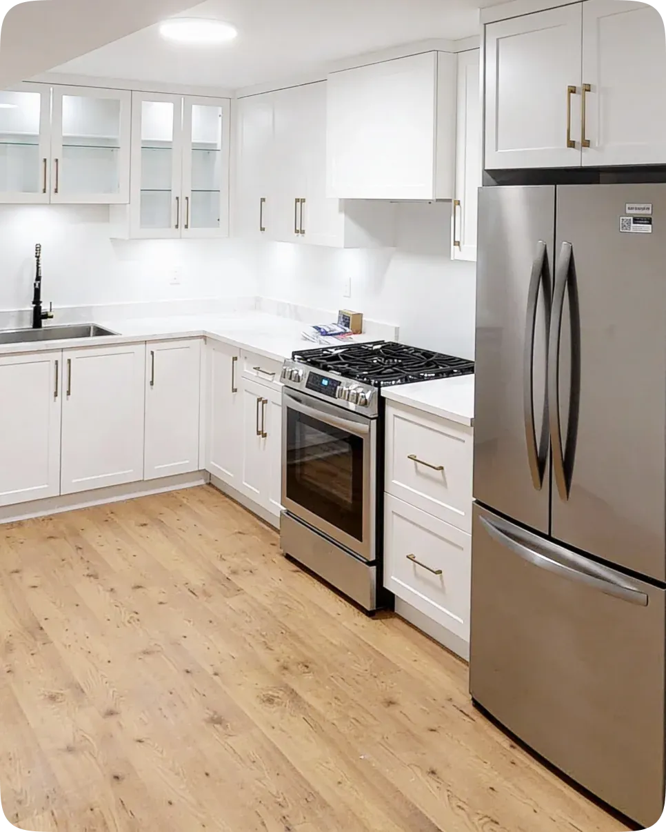 Modern renovated kitchen with white cabinetry and an island, completed by PCC Renovations