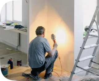 Painter finishing a freshly renovated room