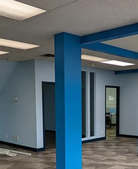 Office interior with freshly painted blue columns and new plank flooring