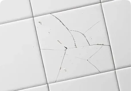 Cracked bathroom tile with damaged grout