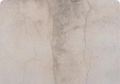 Close-up of a wall with faded, streaked paint colour